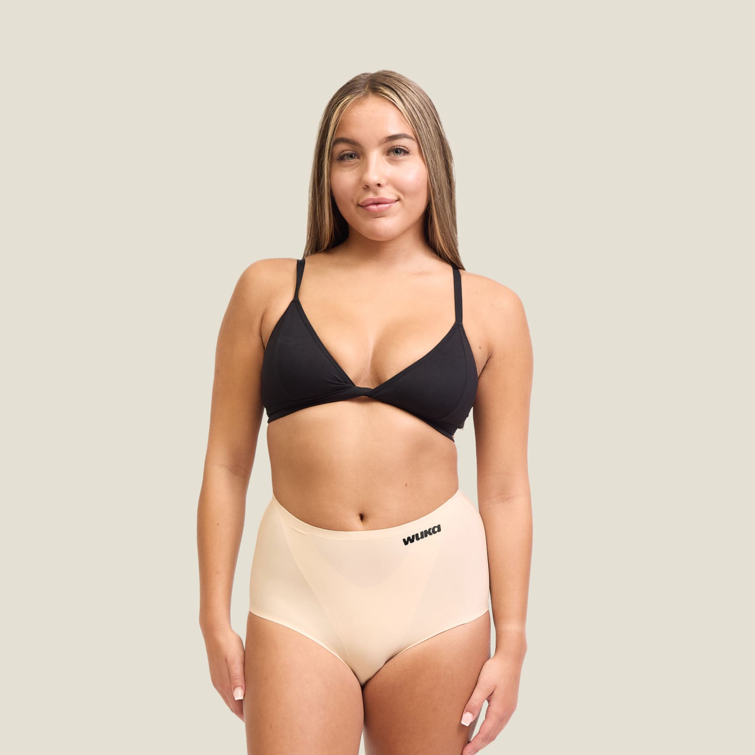Model wearing WUKA Stretch Seamless High Waist Period Pants in Light Nude for heavy flow, showcasing full-body fit and comfort.