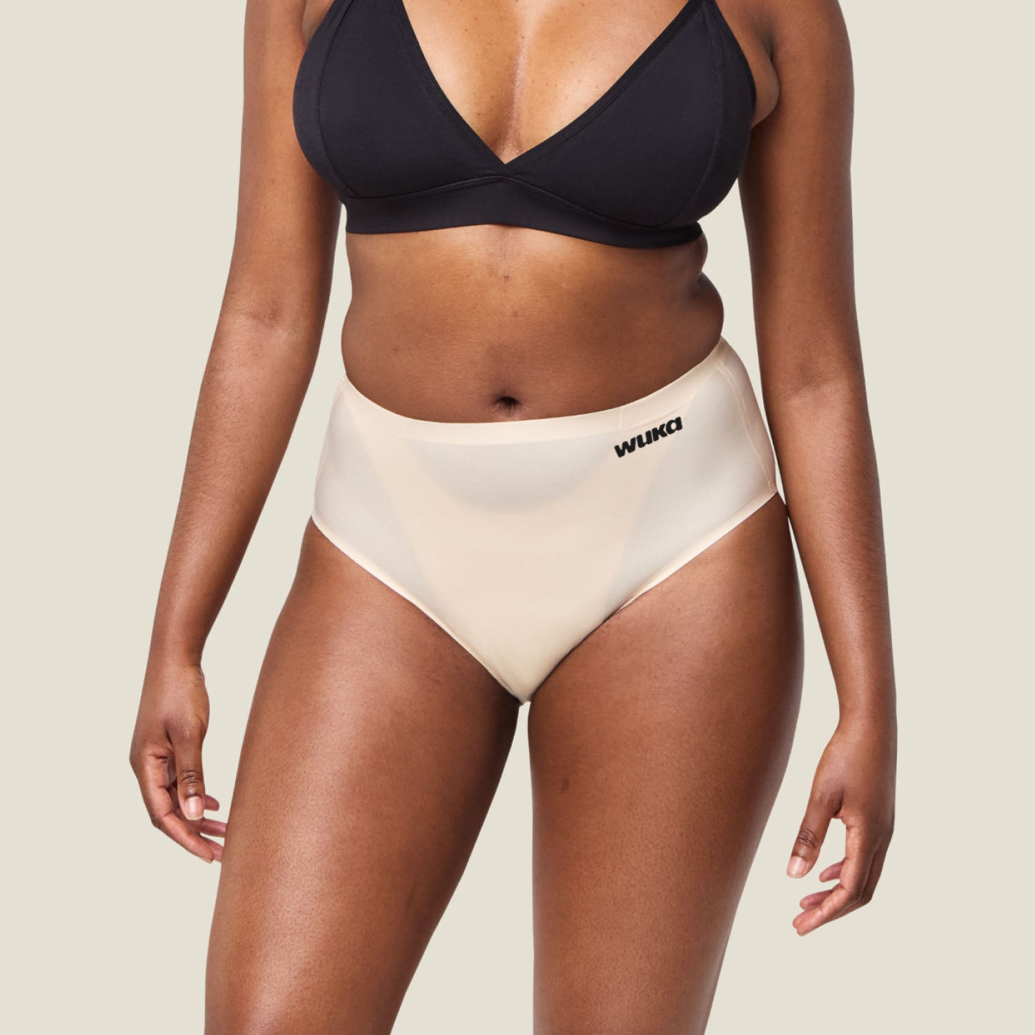 Close-up front view of WUKA Stretch Seamless Midi Brief Light Flow in Light Nude, highlighting smooth fabric and seamless design.