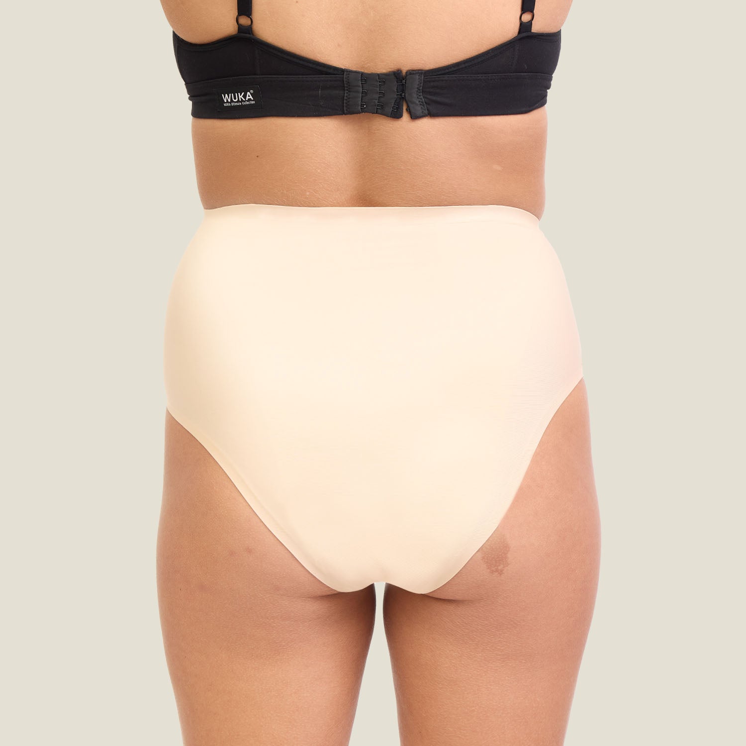 Back view of WUKA Seamless High Waist Heavy Flow Period Underwear in Light Nude showing full coverage and seamless finish.
