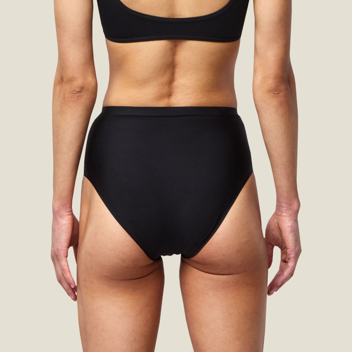 Back view of WUKA Stretch Seamless Midi Briefs in black, showing full coverage design for leak-proof light period protection.