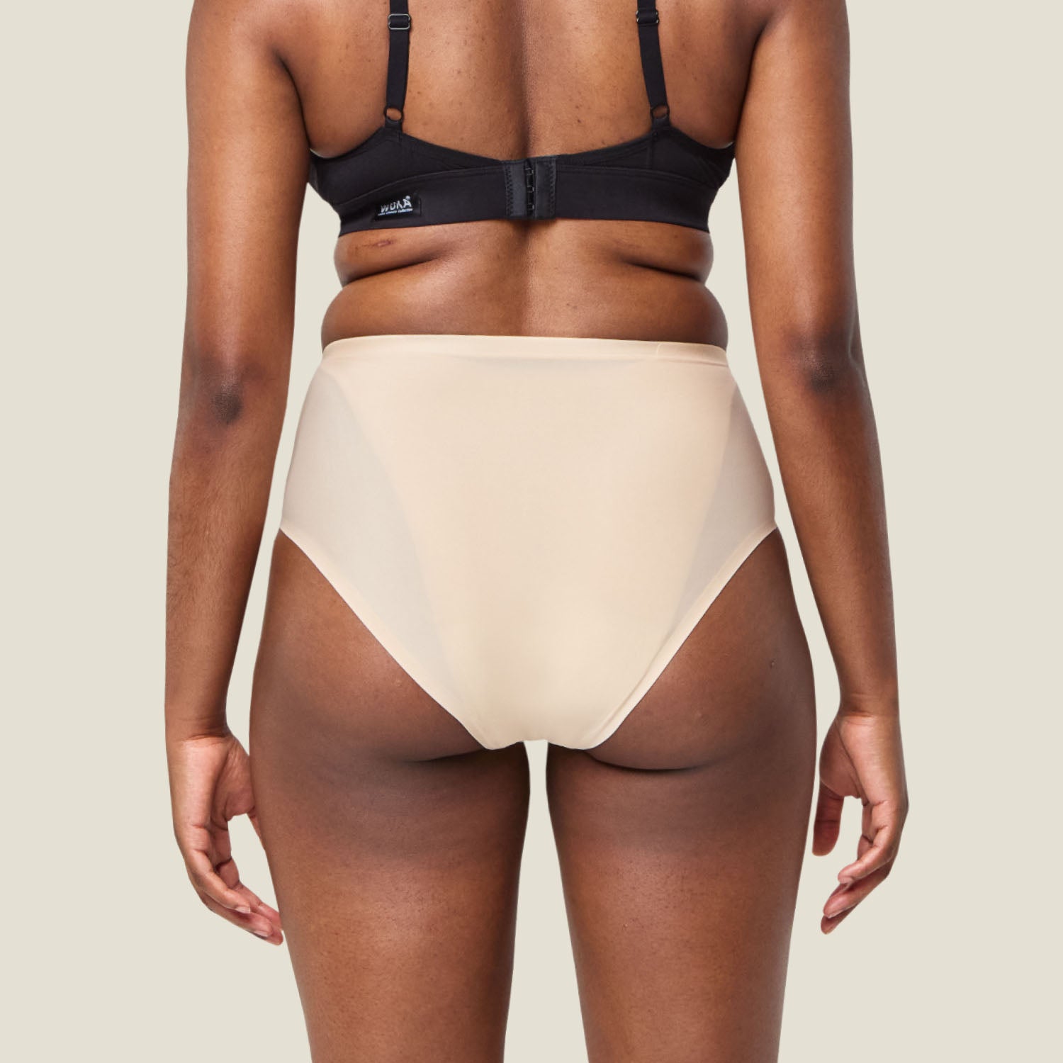 Back view of WUKA Stretch Seamless Midi Brief Light Flow in Light Nude, illustrating full coverage and stretchable waistband.