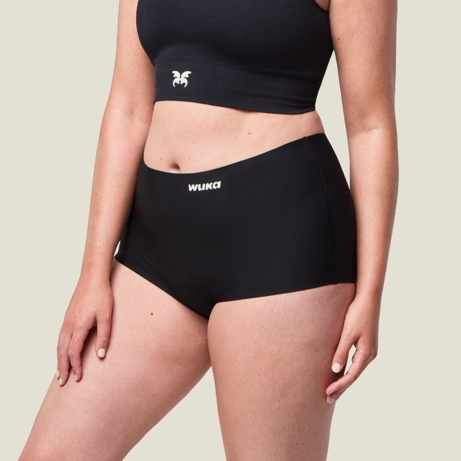 Side profile of black WUKA Stretch™ Boxer Short, highlighting body-contouring fit and discreet absorbent lining for heavy period flow.