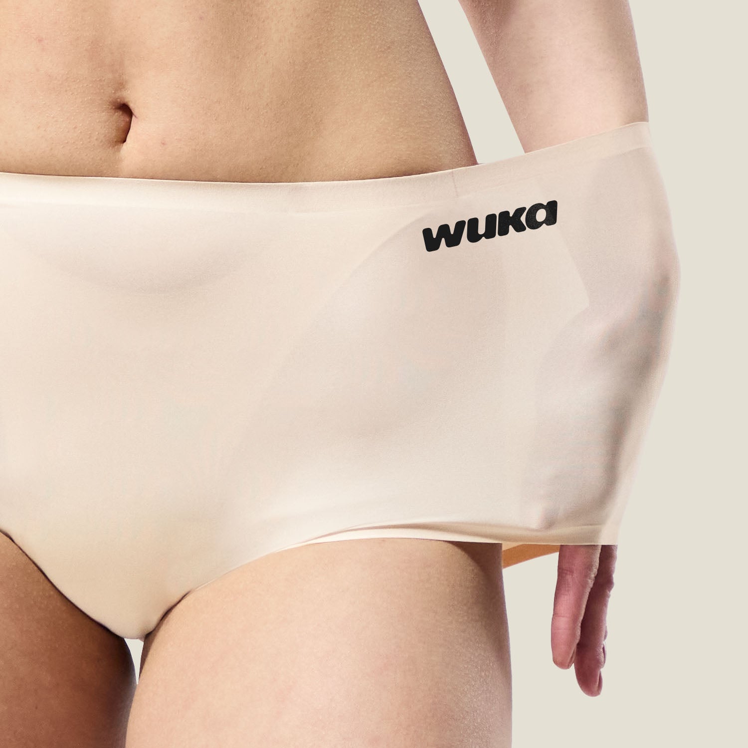 Close-up of WUKA Stretch™ Boxer Short in Light Nude being stretched, demonstrating flexible fit for up to 4 sizes.