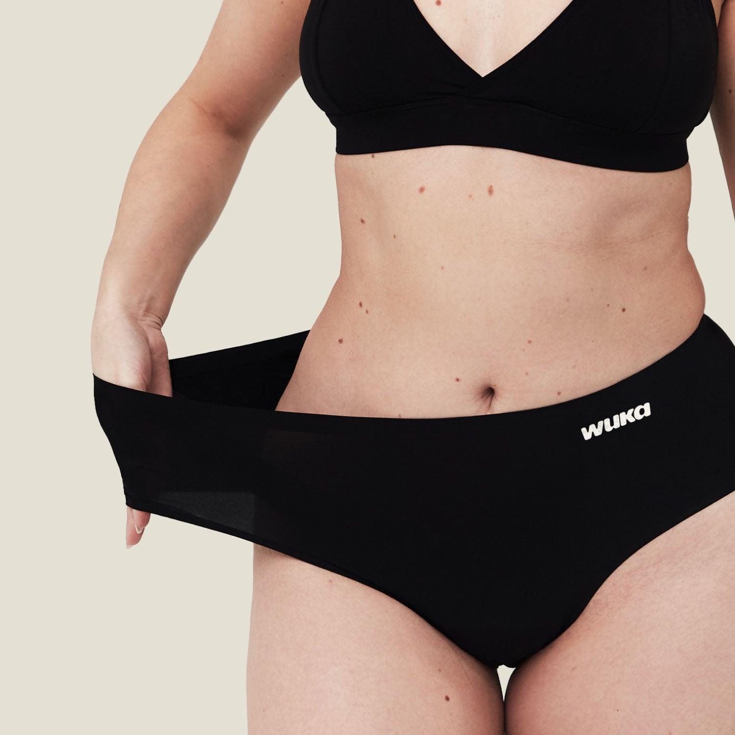 Demonstration of WUKA Stretch™ Period Underwear's super-stretch waistband, fitting a wide range of body sizes comfortably.