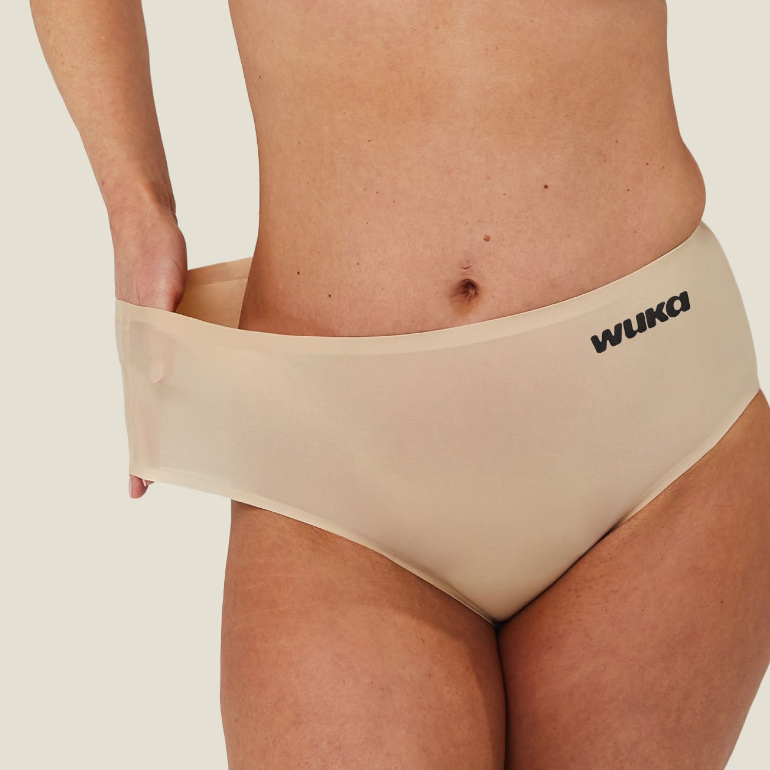 Detail image of WUKA Stretch Seamless Midi Brief Light Flow in Light Nude, focusing on waistband stretch and soft fabric.