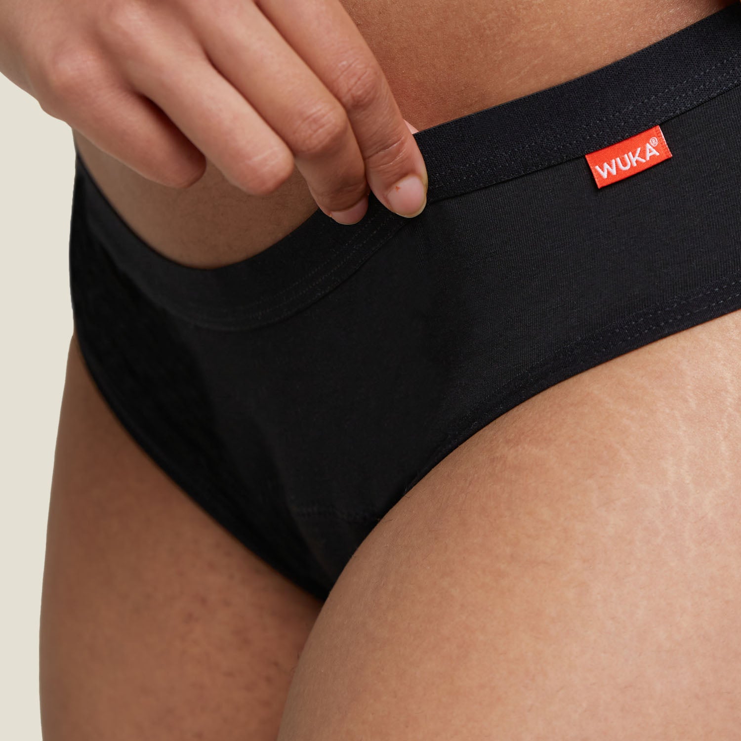 Zoomed-in detail of WUKA branded waistband on the Basics™ Hipster period pants, showing quality stitching and fabric.