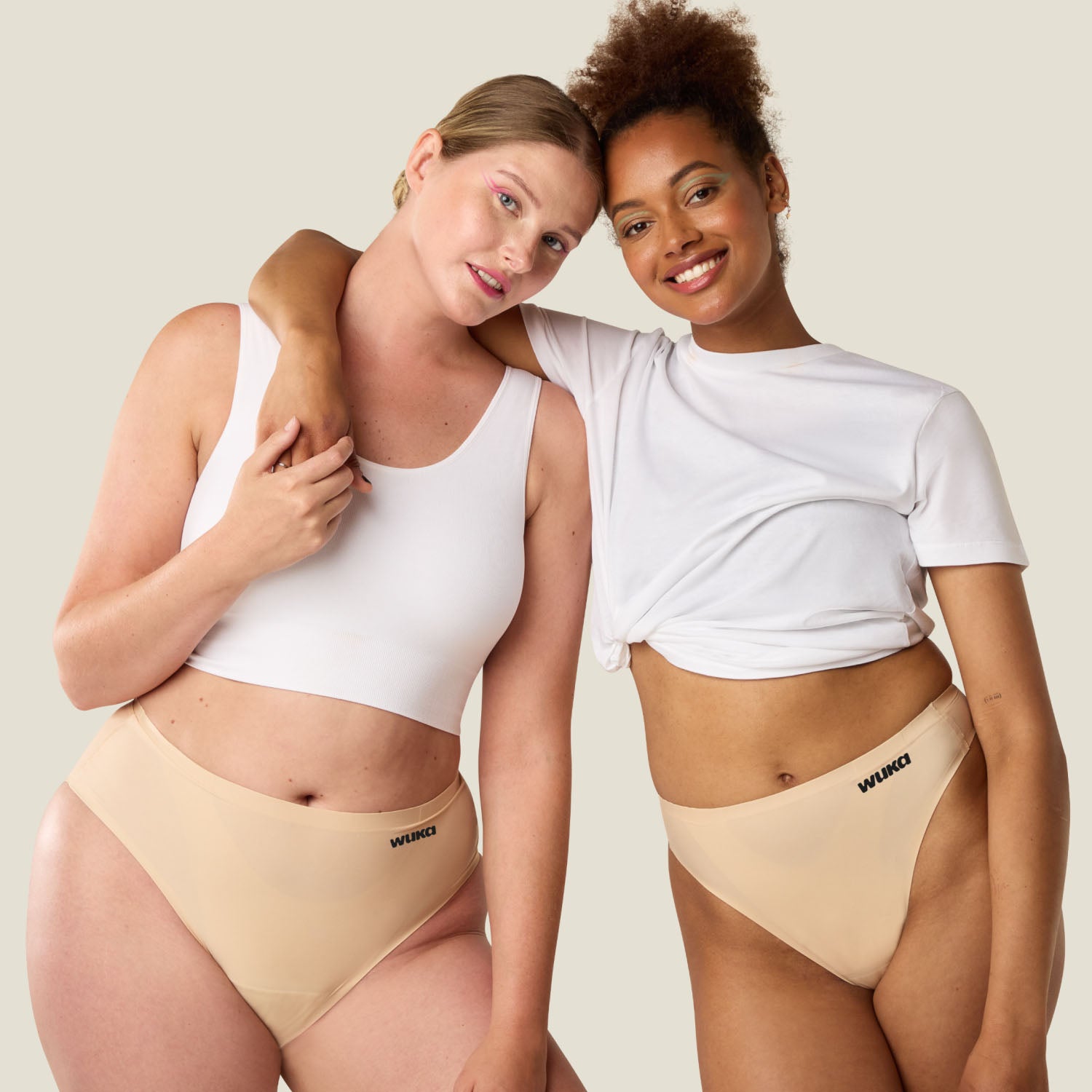Two models wearing WUKA Stretch Seamless Midi Brief Light Flow in Light Nude, celebrating body inclusivity and comfortable period wear.