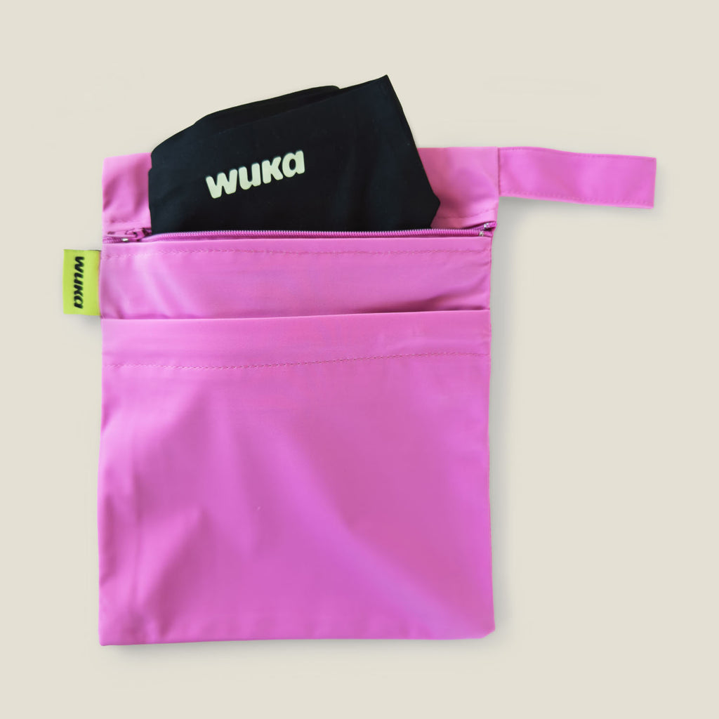 WUKA pink two-pocket period changing bag with one compartment holding clean reusable period pants