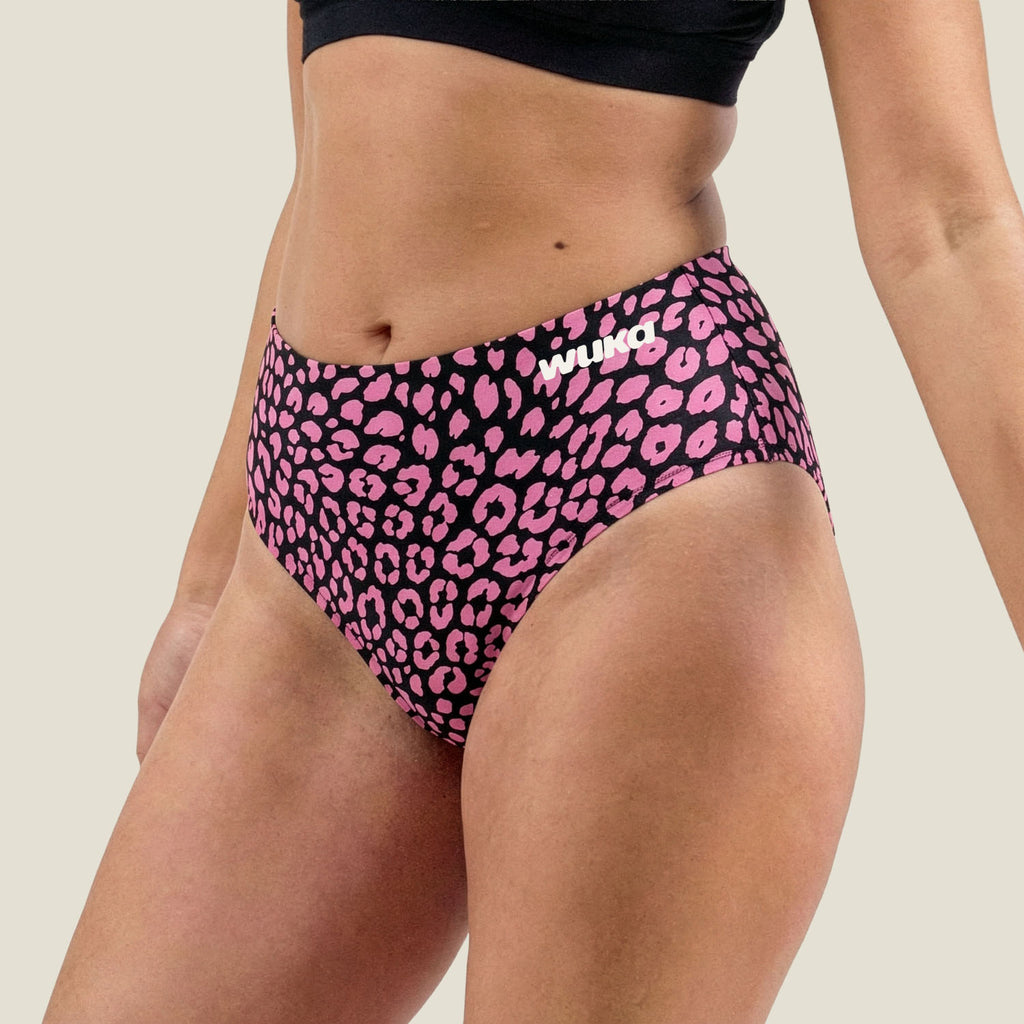 Side angle of WUKA pink leopard print midi brief – stretch-fit period underwear for heavy flow days, hugging curves with secure comfort