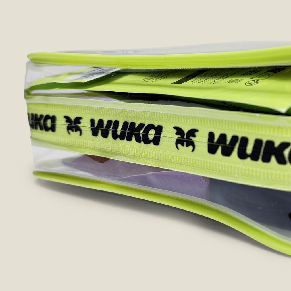 Close-up of WUKA branded zipper on clear period starter kit bag with first period essentials visible inside
